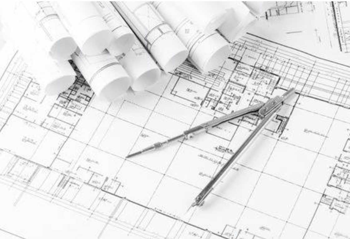 Architectural blueprints and a drafting compass — from design to construction